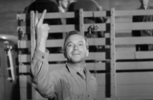Still from Hangmen also Die. One of the Czech hostages gives the No Surrender victory sign before being taken off to be executed by the Nazis