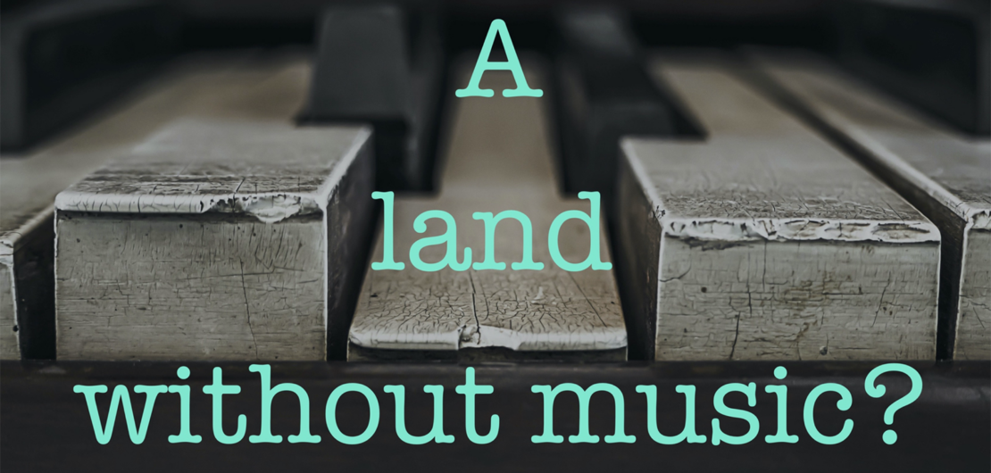 Battered piano keys in black and grey with the text A Land without music?